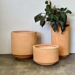 Architectural terracotta pots in a 3-piece set. Minimalist designs for versatile indoor and outdoor plant styling